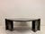 A sculptural low table in dark fossil stone or marble, dating to the late 20th century. The organically shaped top is...