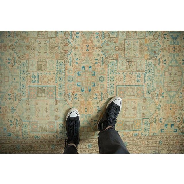 :: Allover covered field in geometric repeating shield medallion design motif arranged in three columns atop a covered...