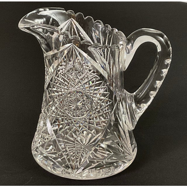 American brilliant.-(ABP)-elaborately cut glass pitcher Circa – 18 96–1916 Sharp precise cuts with hot stars, pinwheels,...