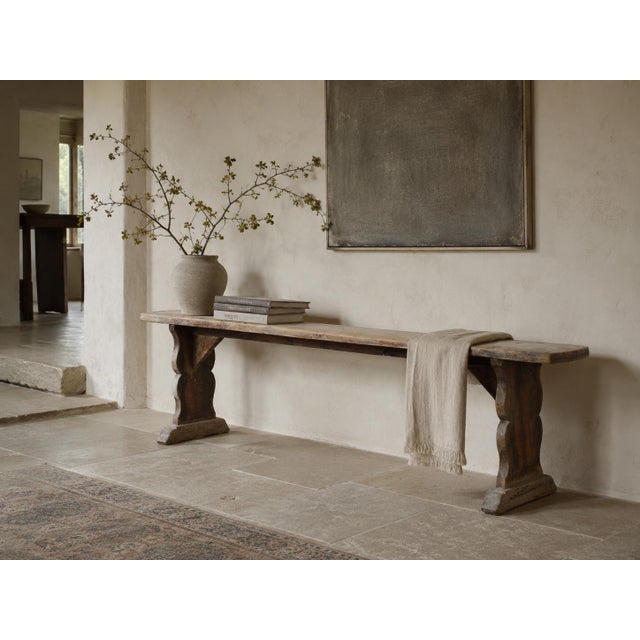 A long French bench, circa 1900, made of solid pine and finished in a dry, pale, naturally weathered surface built up over...