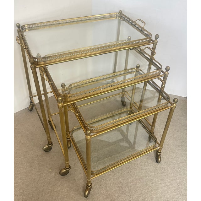 Just in, This set of three French Neoclassical style nesting bar carts, Maison Bagues, from the 20th century. This set has...