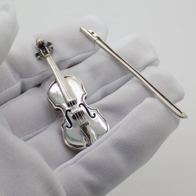 A beautiful vintage object depicting a violin with bow, complete with its original case, handcrafted in Arezzo, Italy...