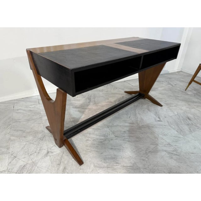 The desk features Buffa’s signature blend of architectural form and refined craftsmanship. It showcases a sleek,...