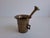 Elegant antique brass mortar and pestle in an art deco-inspired geometric design, originating from czechoslovakia. The...