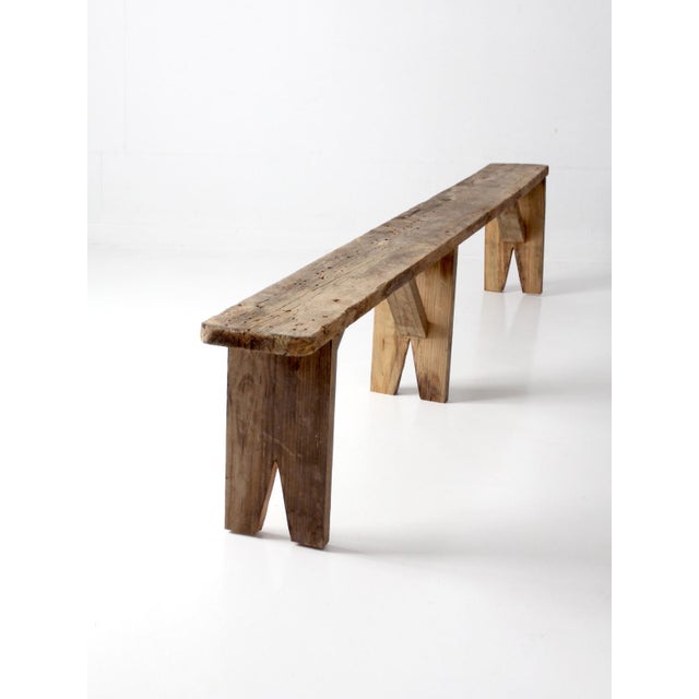 Antique primitive wood bench with an exceptional nine-foot length and beautifully weathered surface. The long, narrow...
