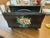 A charming vintage hand-painted metal tôleware magazine rack/caddy finished in matte black. Features a hand-painted floral...