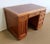 Solid mahogany middle desk covered with a beautiful leather, opening with 6 drawers and a door, and resting on an Art Deco...