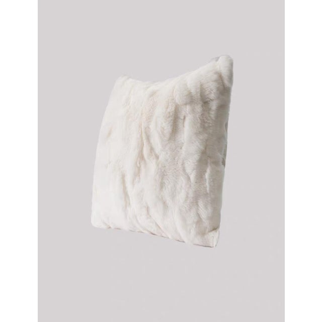 This throw pillow is crafted from delicate faux rabbit fur fabric, featuring pure white fluff that is fluffy and soft. The...