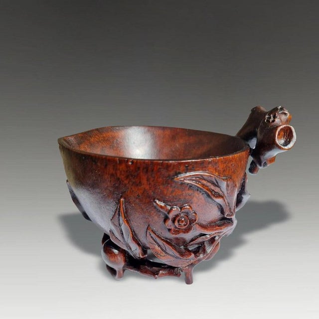 A finely carved Chinese bamboo libation cup dating to the 17th or 18th century and conceived as an elegant scholar's...