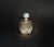 A beautiful natural rock crystal snuff bottle. Carved on the raised exterior, a vase with ruyi and evergreens atop an...