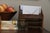 A hand-carved antique wooden bowl with tonal variation and soft edge wear from years of use. Fill it with fruit on a...