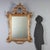 Carved and gilded wood mirror from early 20th century Italy, representing a refined example of decorative craftsmanship....