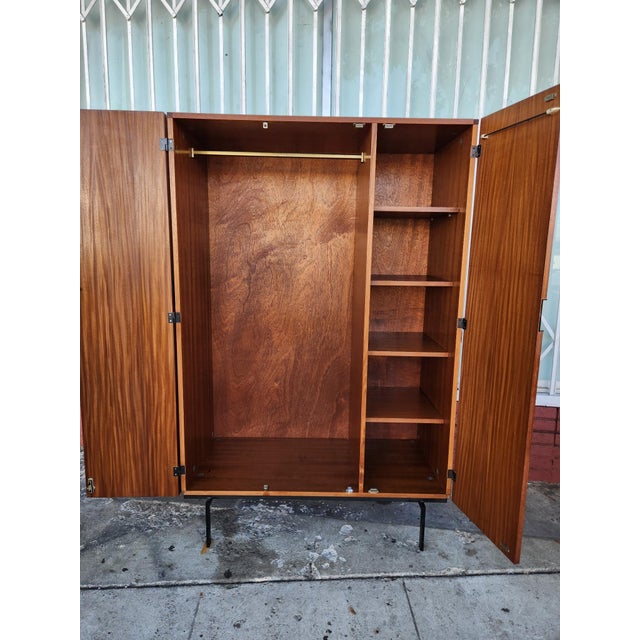 Antique pair of floor-length mirrors constructed from solid pine wood. Each piece has a natural light wood finish with...