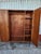 Antique pair of floor-length mirrors constructed from solid pine wood. Each piece has a natural light wood finish with...