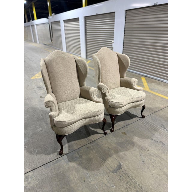 A sophisticated pair of traditional wingback chairs by the renowned Pennsylvania House. This matched set features a...