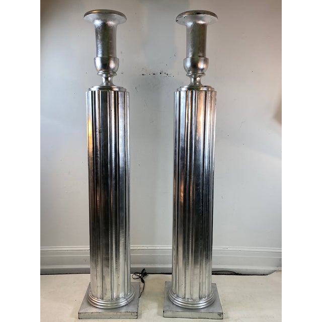Pair of Art Deco revival wood torches. Each measure 16” by 16” at the base and 80” in height.