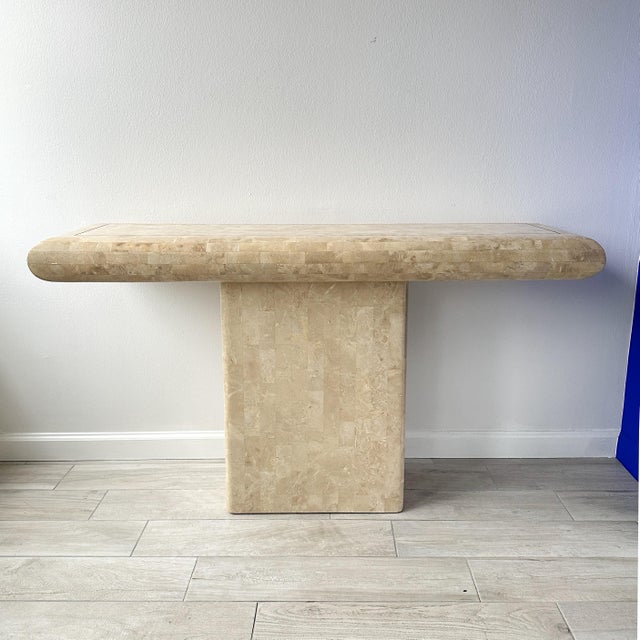 Circa 1970s Maitland Smith tessellated travertine stone console table with brass inlay. Pedestal table with bullnose...