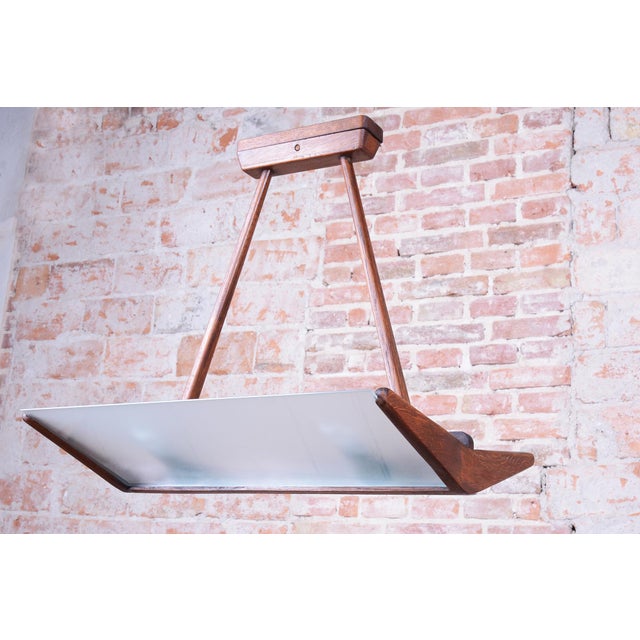 This elegant pendant chandelier originates from the 1950s Czechoslovak design environment and represents a refined example...