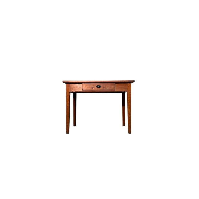 Elegant vintage writing desk made of larch wood, dating back to the early 1900s. Featuring a simple and functional design,...