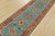 A tribal Caucasian Kazak runner hand-knotted with fine wool on a cotton foundation. This rug features a row of geometric...