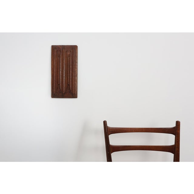A finely carved oak panel from 16th‑century Flanders, featuring Gothic linenfold‑style fluting with pointed‑arch tops and...