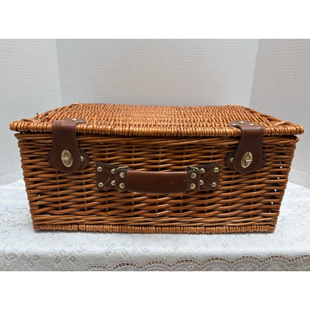 Vintage wicker wood picnic basket with service for two packed neatly inside with checkered Americana lining. Includes 2...