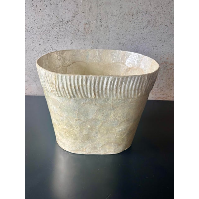 Vintage coastal wastebasket dating to the 1980s, handcrafted from natural capiz shell. Features a softly rounded...