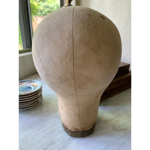 Here we have a nifty old head from a store display for millinery hats. Made of canvas with a wood base, brass collar trim...