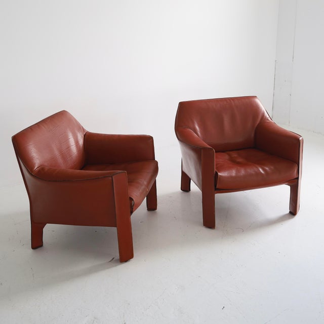 c. 1970s, signed. There is considerable wear and patina but both chairs present well and are very comfortable. There is a...