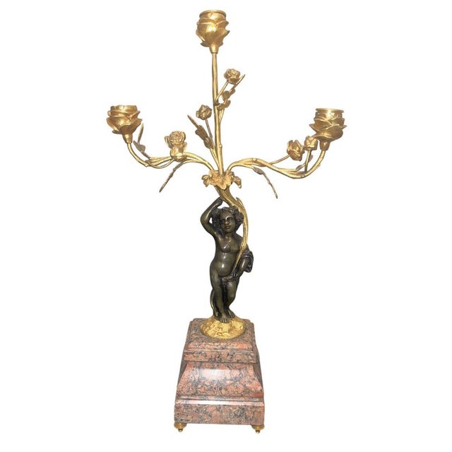 An elegant pair of French Belle Époque figural candelabra, executed in patinated bronze and gilt metal with naturalistic...