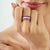 The Art Deco Baguette-Cut Ruby & Diamond Wide Anniversary Band Ring features a bold geometric design inspired by the...