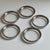 A sophisticated set of five vintage clear glass coasters featuring elegant silver-toned metal rims in the iconic style of...