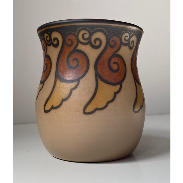 A stylish vase executed in hand-painted terracotta. Decorated in earthy glazes with snails circling around its perimeter....
