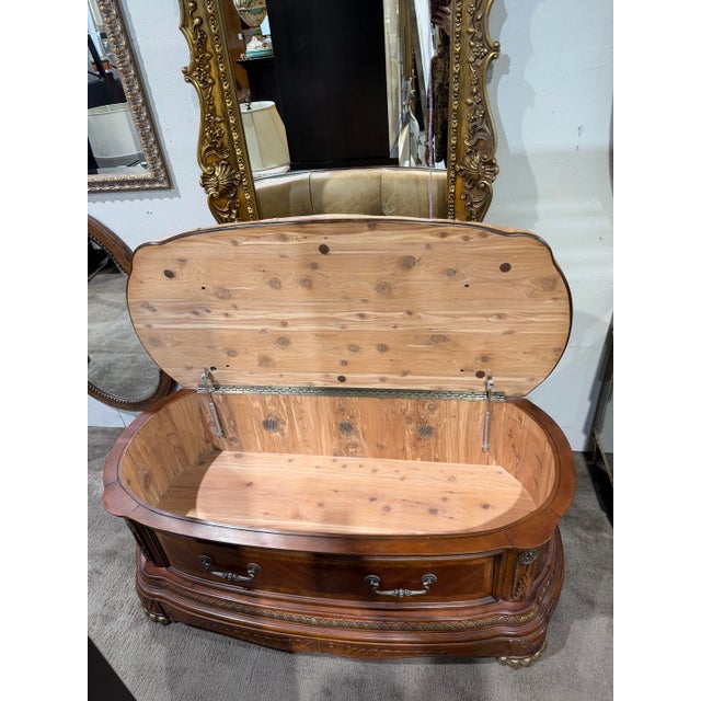 Elegant and functional bedside/storage bench from the “Cortina” collection by Aico Amini. Finished in a rich honey walnut...