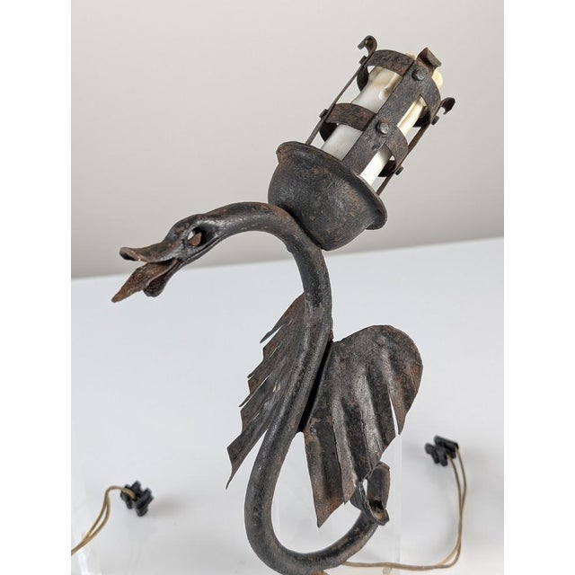 This set of three dragon-shaped sconces captures the essence of handcrafted wrought iron design from the turn of the...