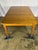 A large extendable pine farmhouse table featuring turned legs. The table is finished in a warm wood tone and can be...