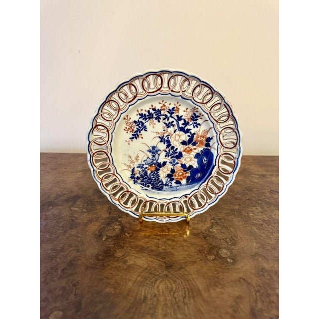 Quality near pair of antique Japanese imari plates, having a quality near pair of antique Japanese plates having a pierced...