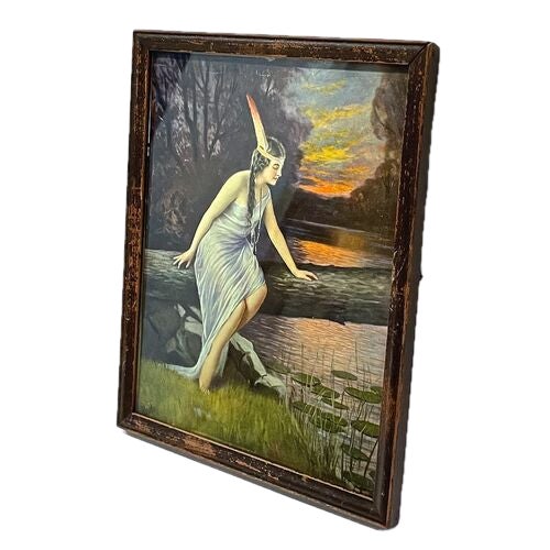 Vintage Native American woman sitting on a fallen tree framed print. Signed "Reale" on the lower left corner.