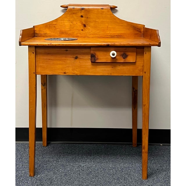 Awesome antique 19th century primitive pine washstand. Featuring a unique raised gallery with rolling pin style top. The...