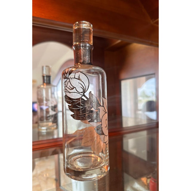 Offering a vintage silver overlay decanter from mid-20th century. Manufactured by the Rockwell Silver Company known for...