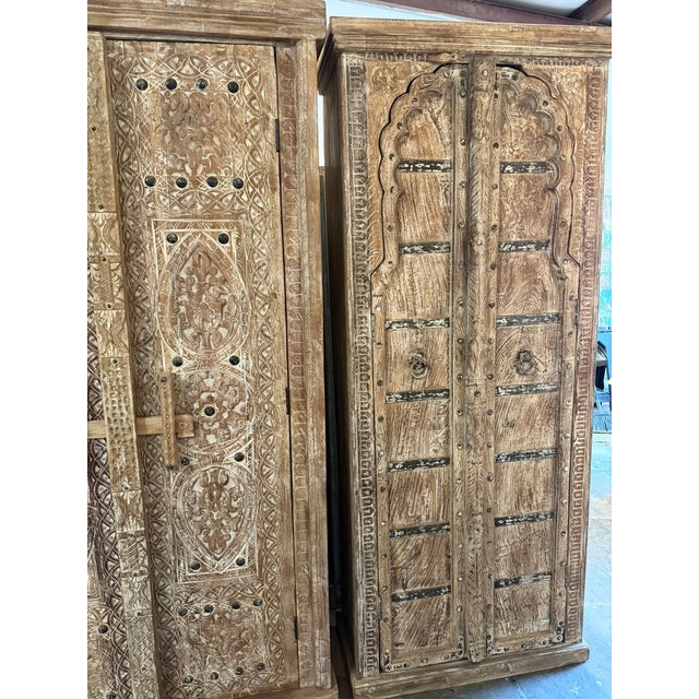 Elevate your space with this antique-style arched door cabinet, a striking tall farmhouse armoire finished in a soft...