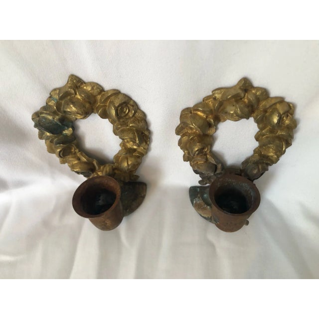 Chandelier Orne De Bronze (a pair), AVOIR’s custom designed pair of candlestick holders, are made from pieces of antique...