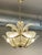 A vintage palm-style Murano glass chandelier by Venini is a decorative Italian light fixture made from hand-blown glass on...