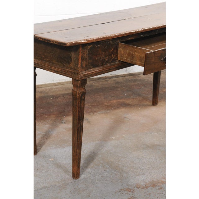 A Brazilian peroba wood console table, with single drawer, from the 19th century. This antique peroba wood table from...