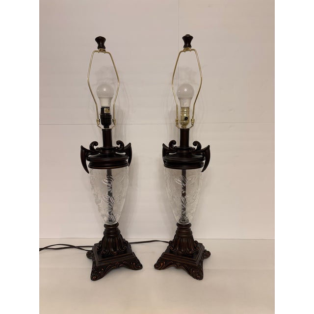 Add a touch of classical elegance to your space with this striking pair of 1980's table lamps. Designed in the...