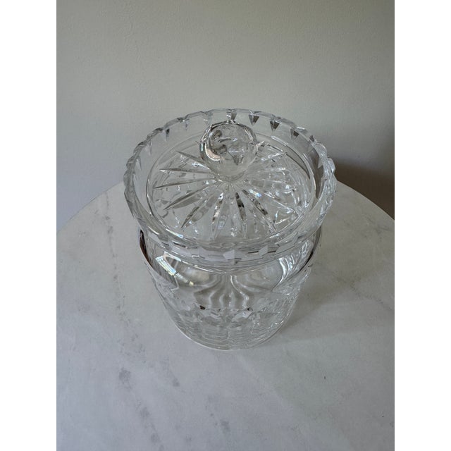 A beautifully crafted cut crystal biscuit jar with matching lid, circa 1950s–60s. The cylindrical body features an all-...