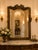 An exceptional and richly detailed antique French giltwood mirror, featuring an elaborate hand-carved crest of cascading...