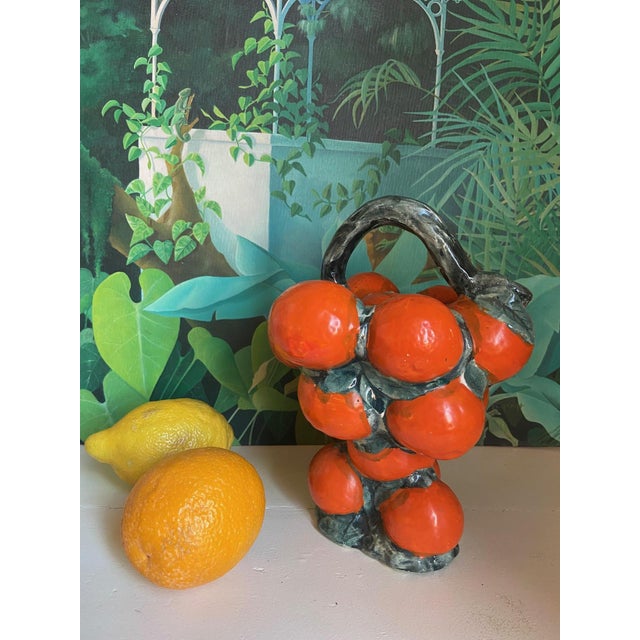 Hand-glazed Spanish gargoulette — traditional ceramic water pitchers from southern Spain — shaped as a clementine open in...