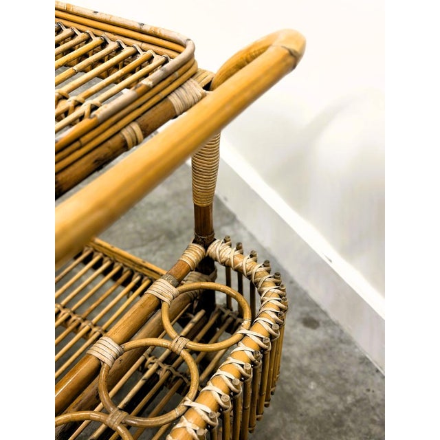 A beautiful 1970s italian rattan bar cart, handcrafted with tightly wrapped cane and elegantly curved lines. This light,...