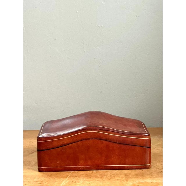 This vintage Italian decorative box is wrapped entirely in rich, saddle-brown leather, its sculptural lid rising and...